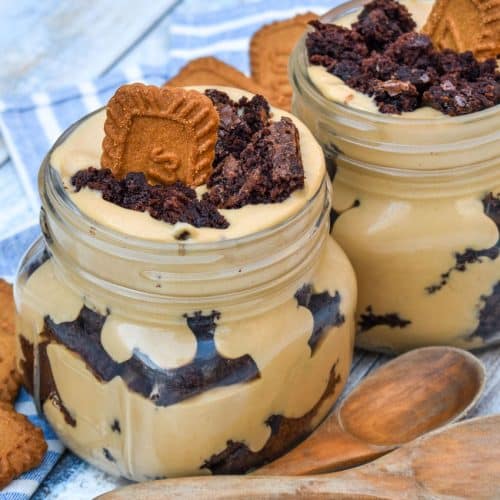 two brownie trifles with cookie butter in small mason jars