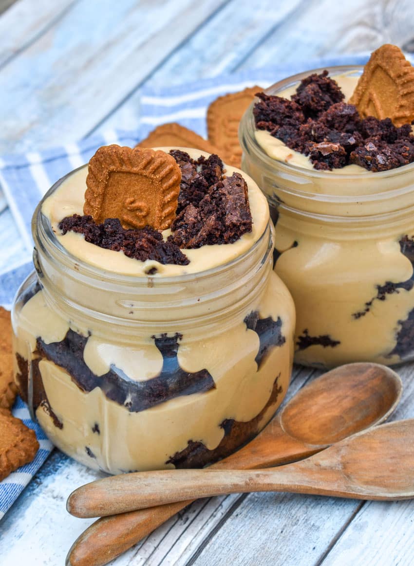 two brownie trifles with cookie butter in small mason jars