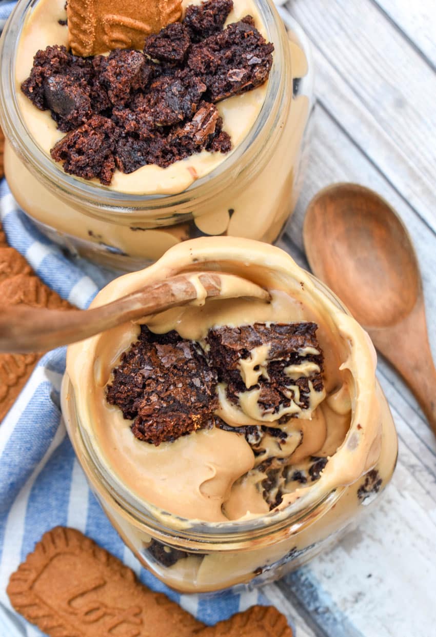 two brownie trifles with cookie butter in small mason jars