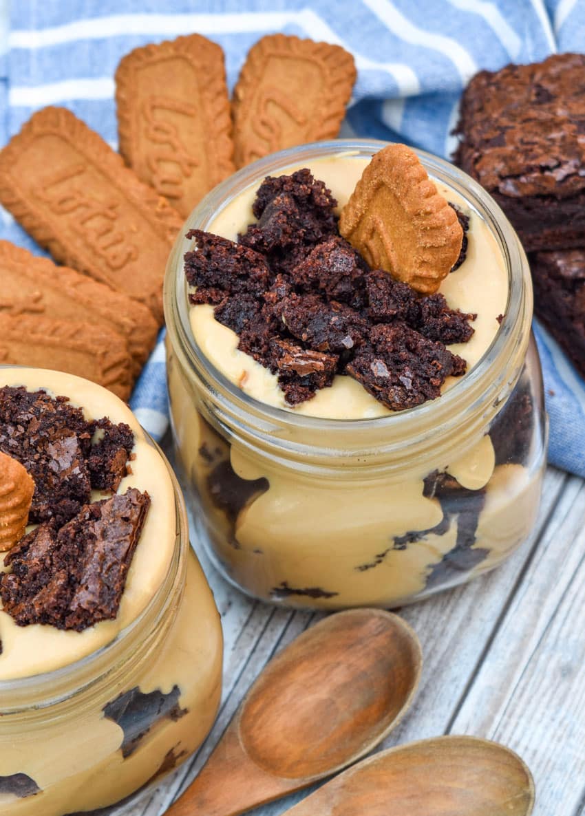 two brownie trifles with cookie butter in small mason jars