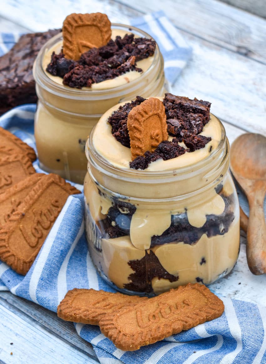 two brownie trifles with cookie butter in small mason jars
