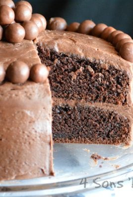 chocolate malt cake with a slice removed to reveal the inside layers