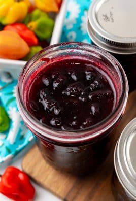 fresh cherry habanero jam in a small glass mason jar