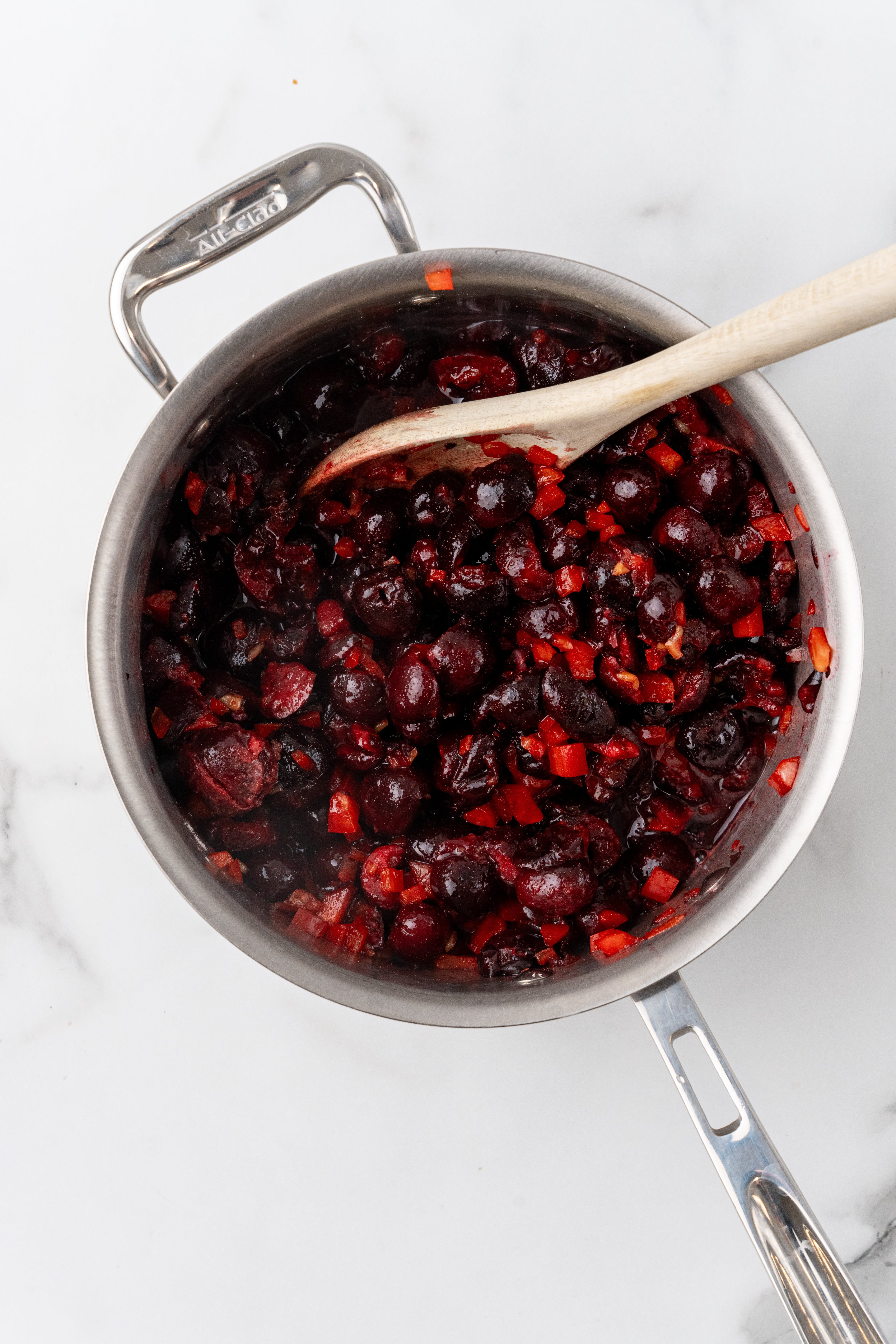 chopped cherries and diced vegetables in a small metal pot