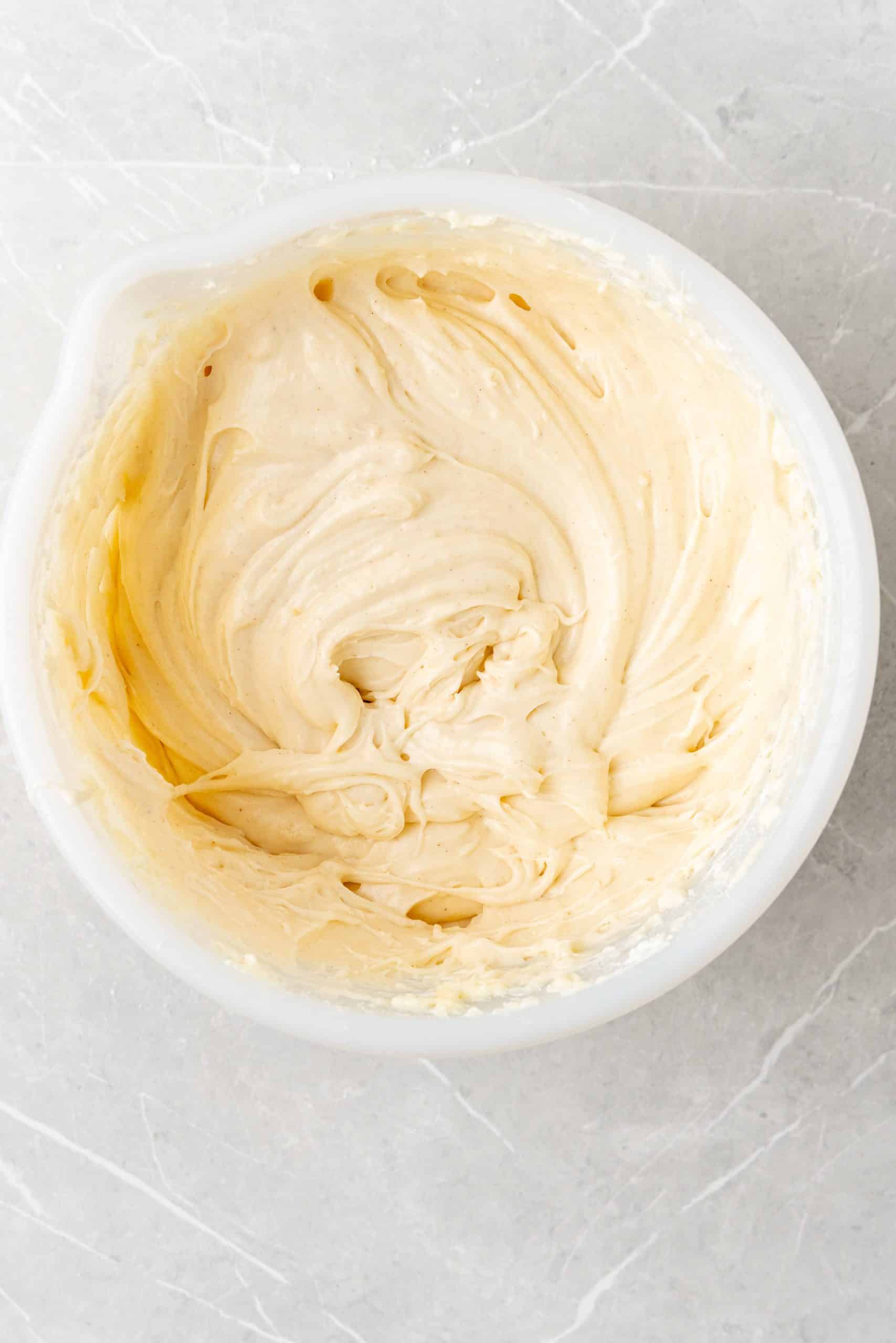 apple butter cinnamon cream cheese frosting in a white mixing bowl