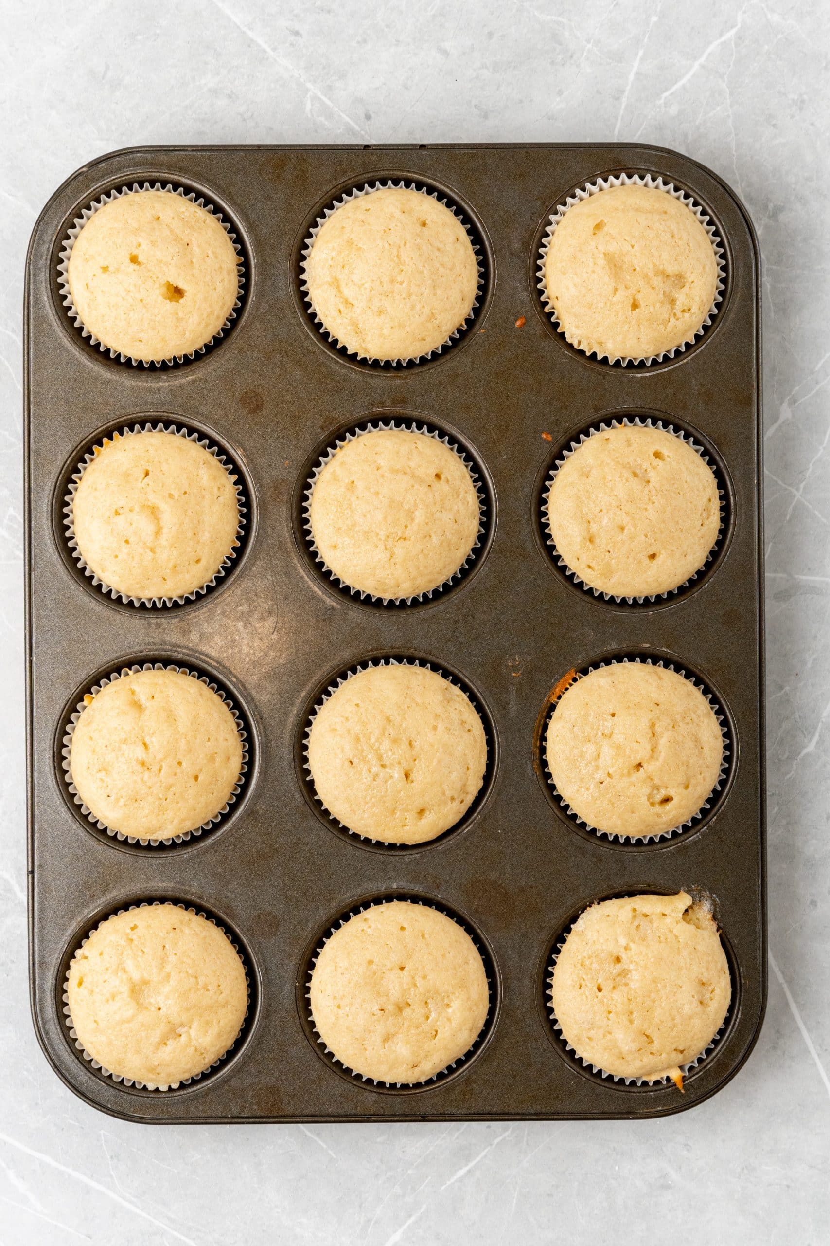baked apple butter cupcakes in a metal muffin tin
