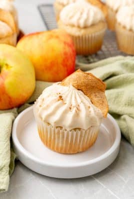 a frosted cinnamon apple butter cupcake on a small white plate