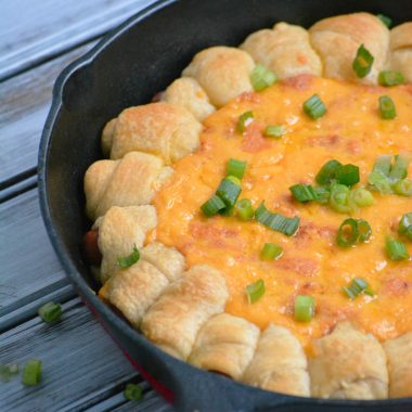 CHILI CHEESE DOG DIP WITH PULL APART PIGS IN A BLANKET IN A CAST IRON SKILLET