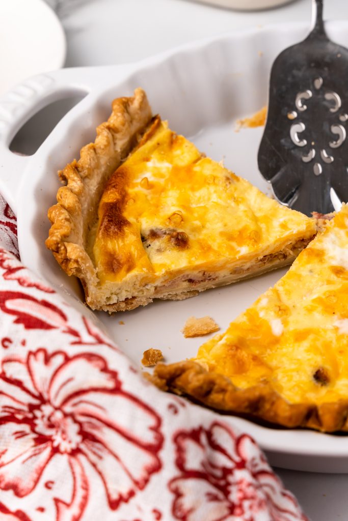 sliced cheddar bacon ranch quiche in a white pie plate
