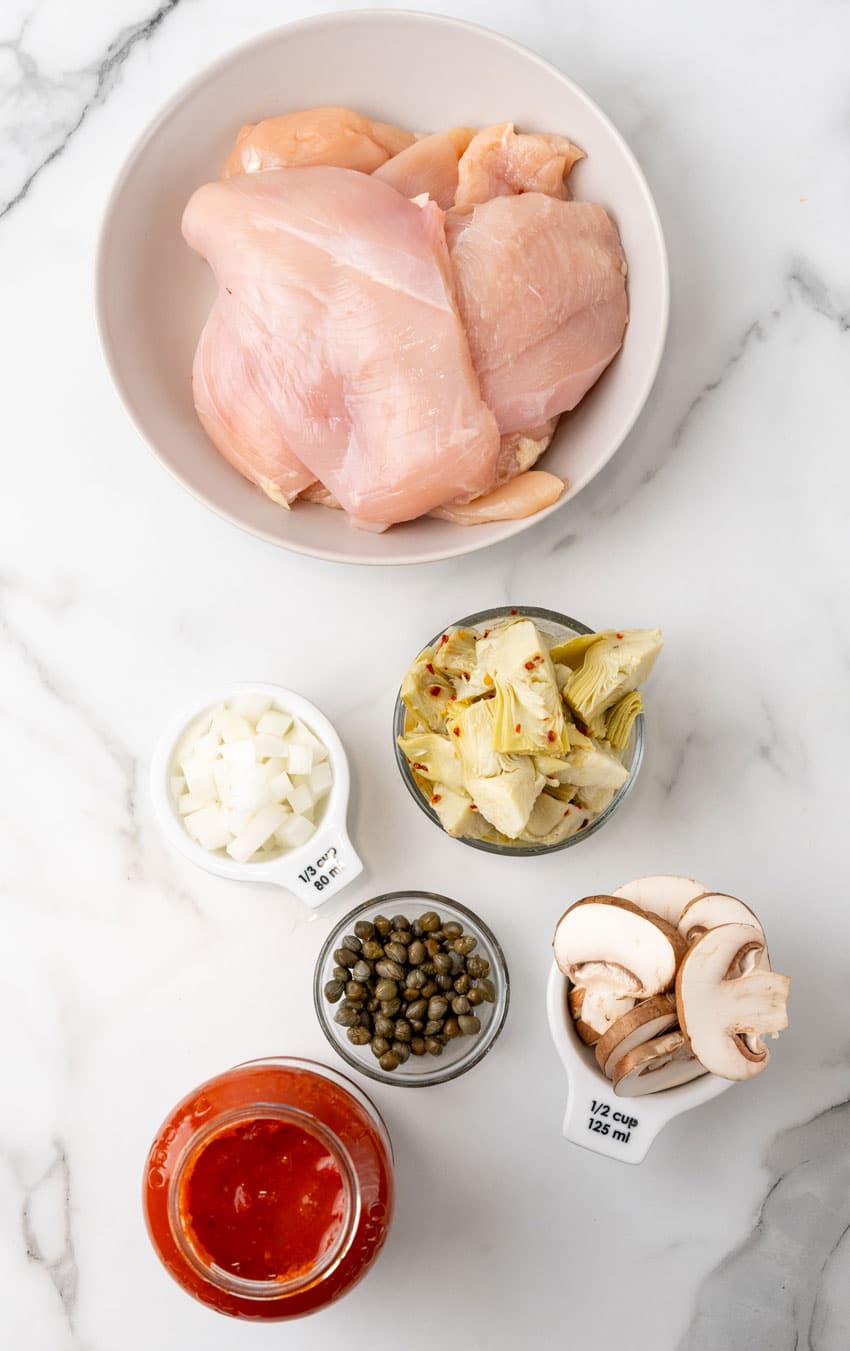 an overhead image showing the measured ingredients needed to make an easy tuscan chicken dinner