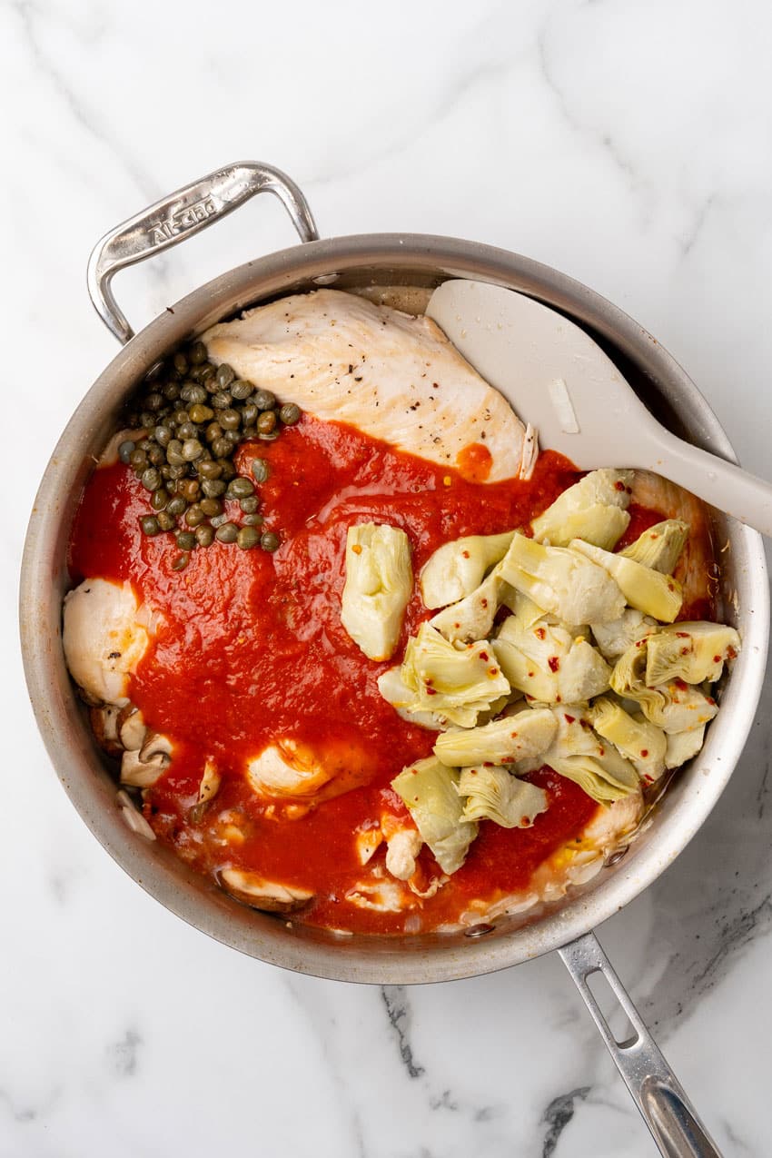 easy tuscan chicken ingredients in a large metal skillet