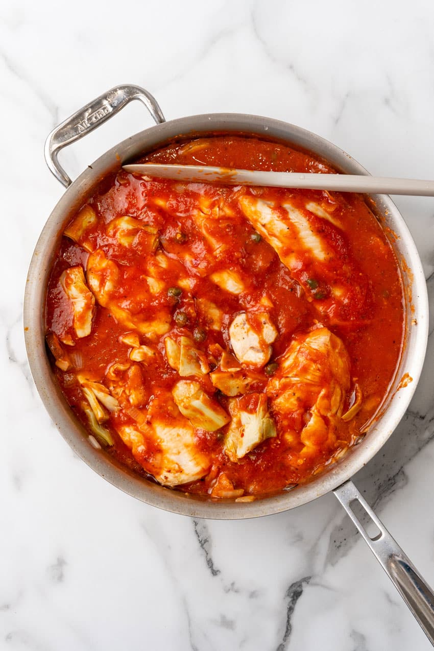 one pot tuscan chicken in a large metal skillet