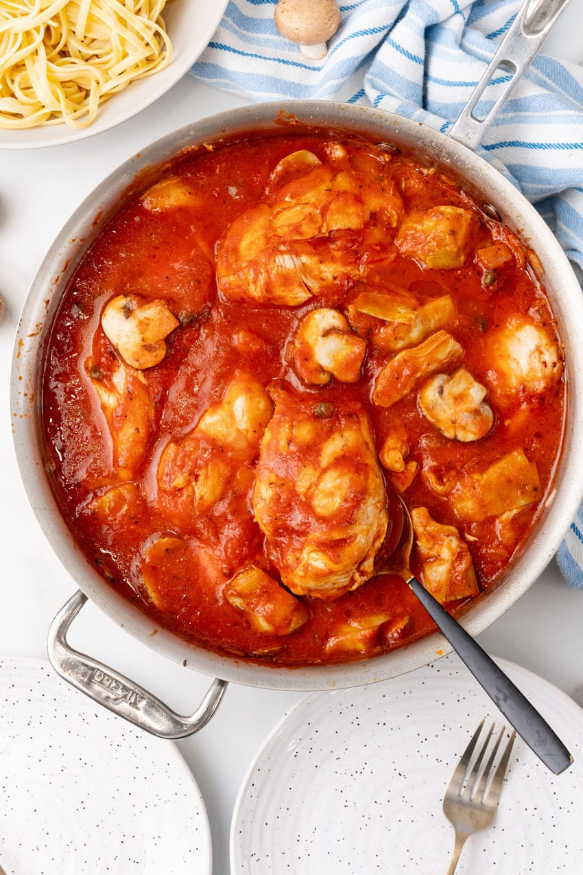 one pot tuscan chicken in a large metal skillet