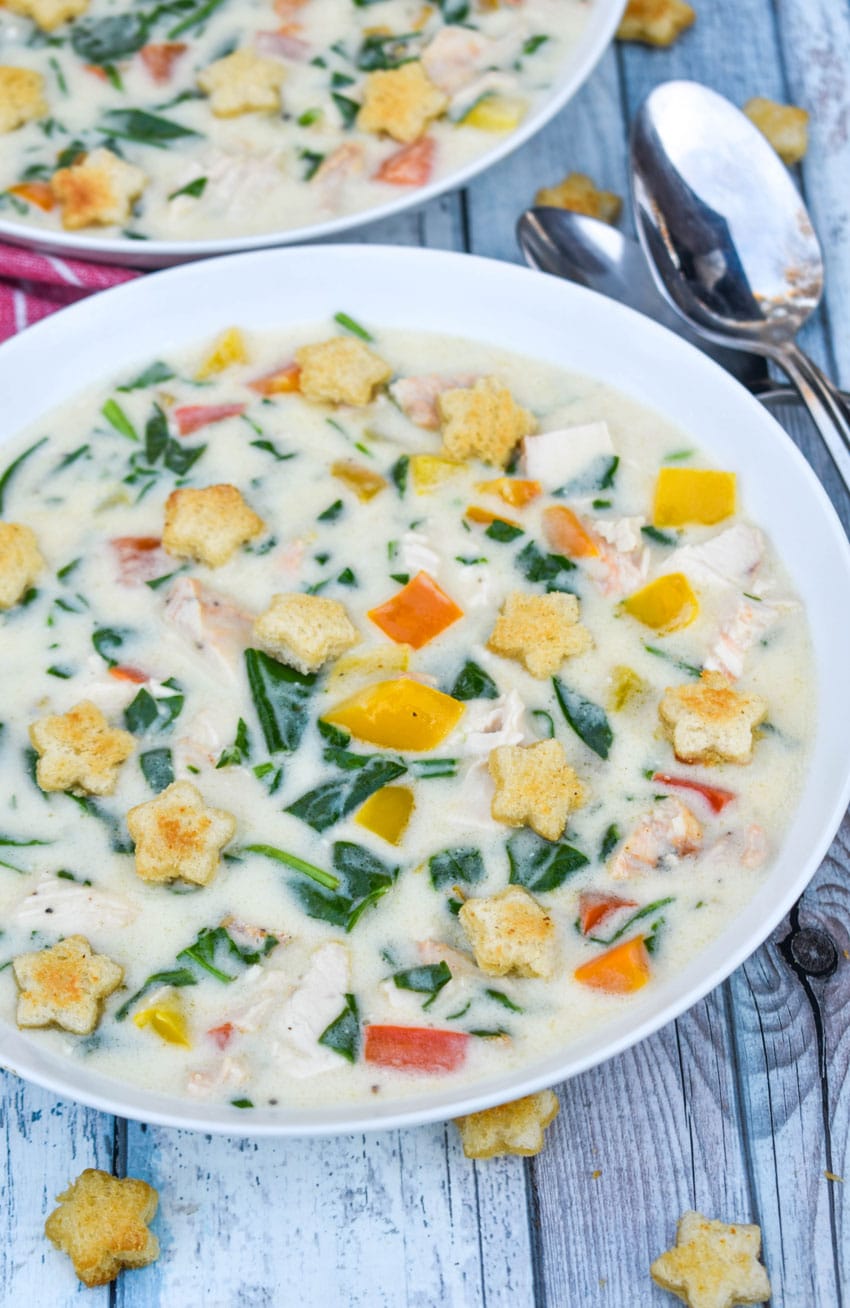 christmas confetti soup with homemade croutons in a shallow white bowl