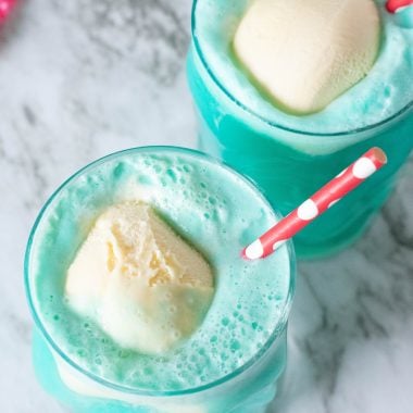 bright blue party punch has scoops of vanilla ice cream floating in it for a visual snowball effect