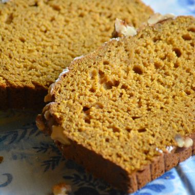 two slices of vanilla pumpkin cake bread on a blue cloth napkin