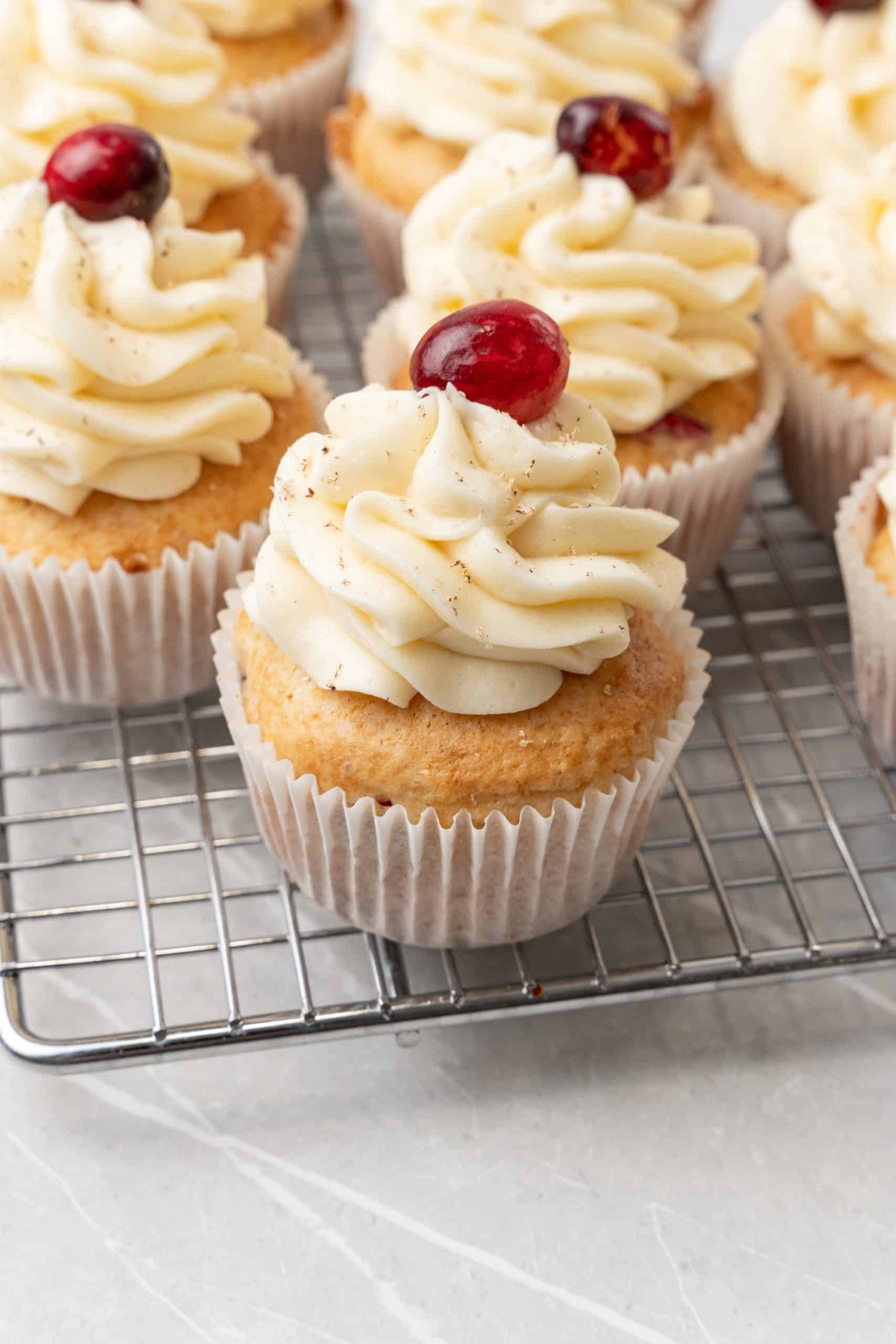 cranberry eggnog cupcakes on a wire rack