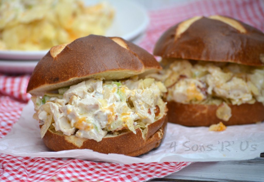 two hot potato chip chicken salad casserole sandwiches on pretzel buns