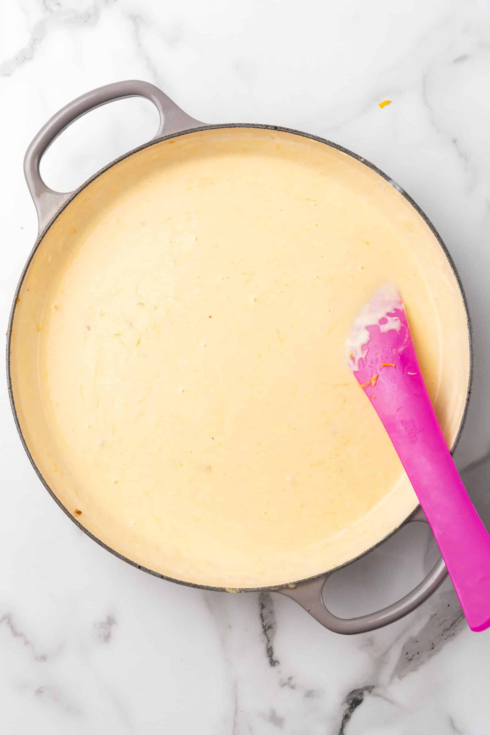 creamy homemade cheese sauce in a large gray skillet
