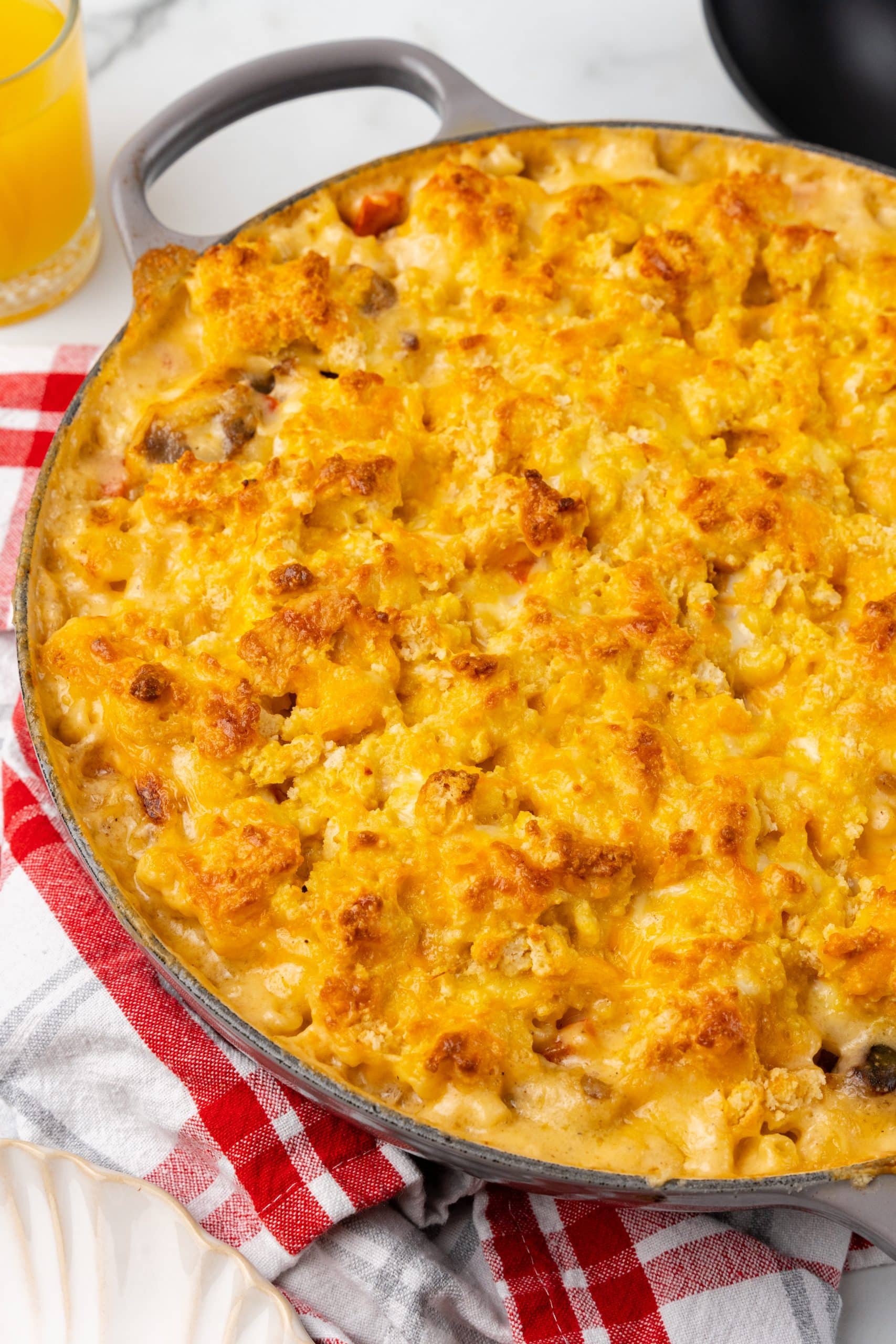 cheesy baked breakfast pasta in a large gray skillet