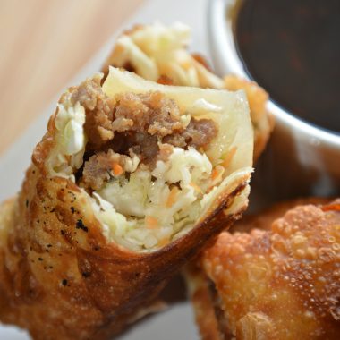 crispy homemade egg roll broken open to show the filling inside