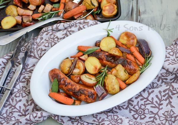 Sausage, Apple, And Herb Sheet Pan Supper shown being served in a white oval dish