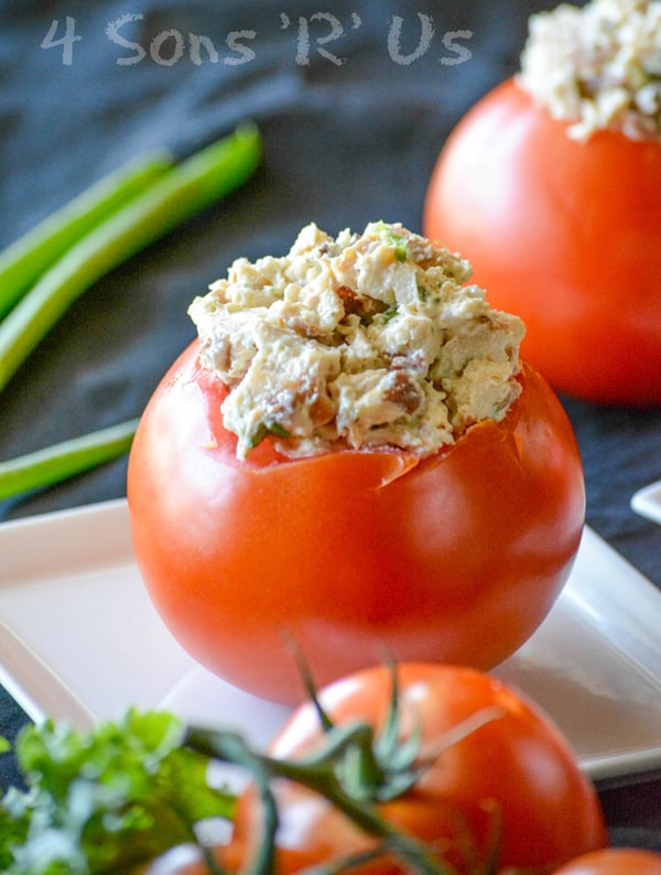 a chicken bacon ranch stuffed tomato on a small white appetizer plate