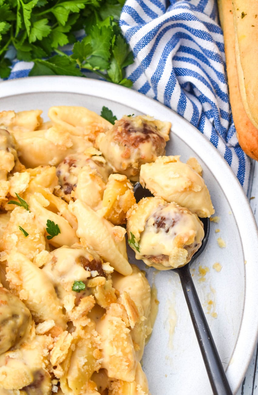 mac and cheese with meatballs on a white plate