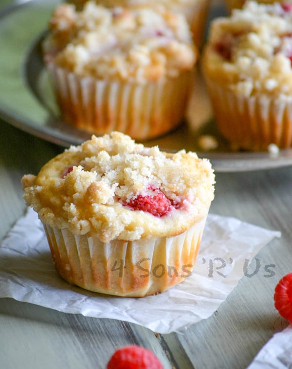 a raspberry lemon yogurt muffin on a small square of white parchment paper