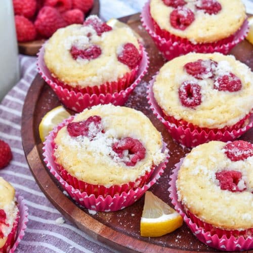 raspberry lemon yogurt muffins on a wooden cake stand