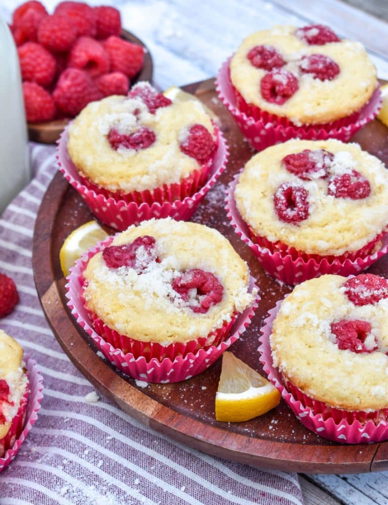 raspberry lemon yogurt muffins on a wooden cake stand