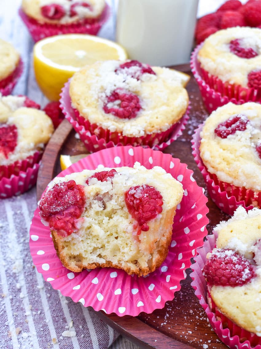 raspberry lemon yogurt muffins on a wooden cake stand