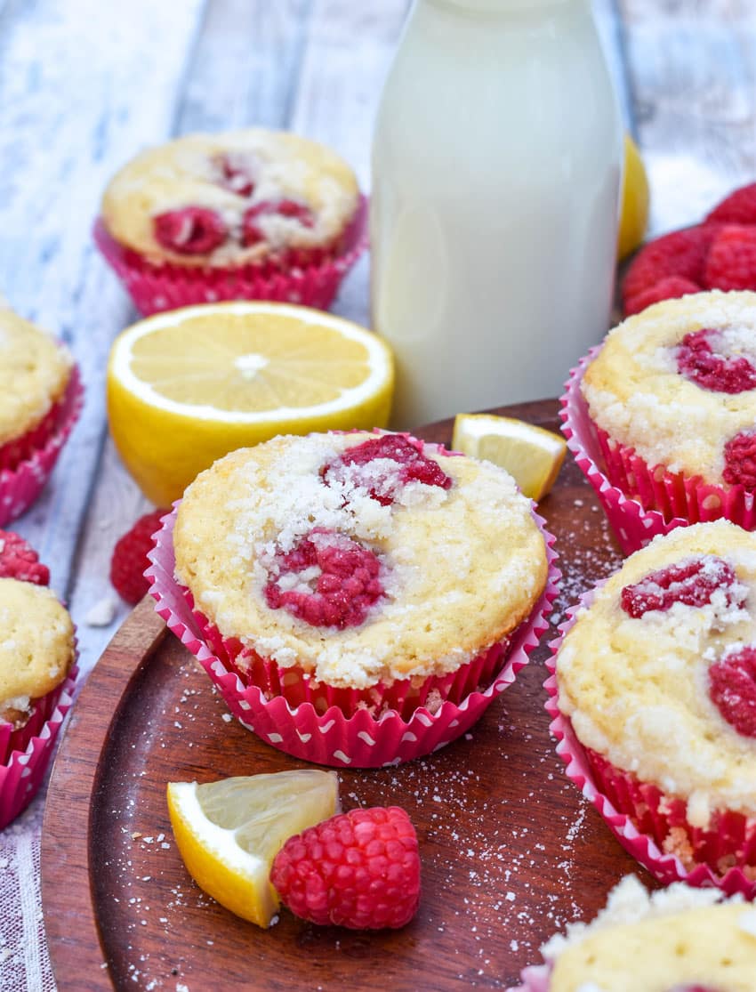 raspberry lemon yogurt muffins on a wooden cake stand