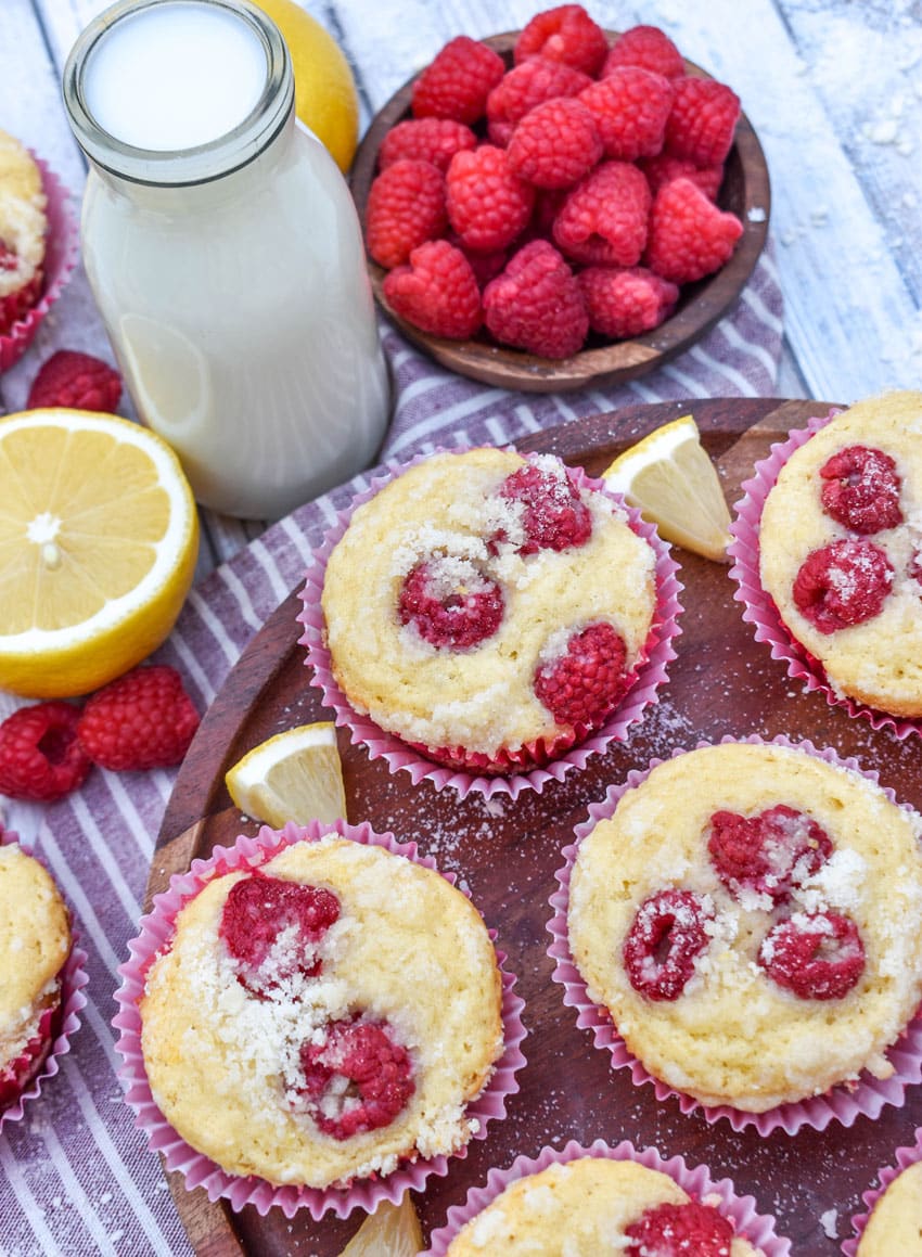 raspberry lemon yogurt muffins on a wooden cake stand
