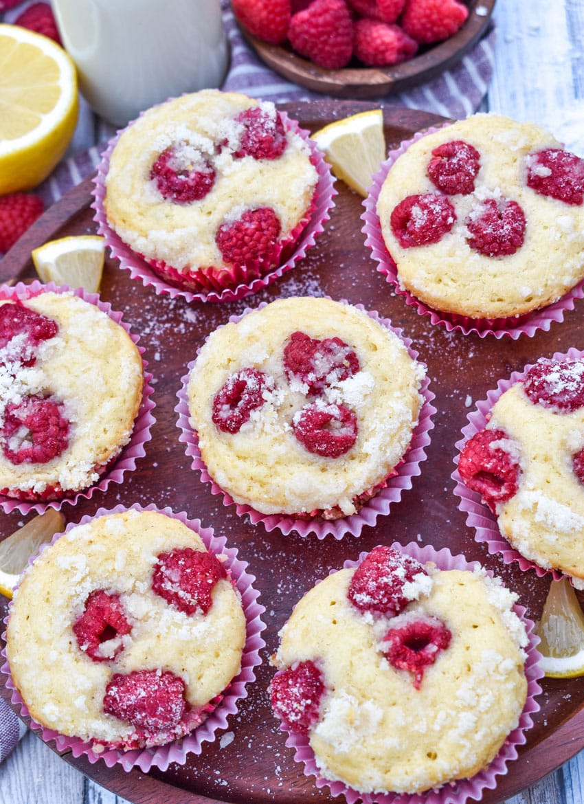 raspberry lemon yogurt muffins on a wooden cake stand