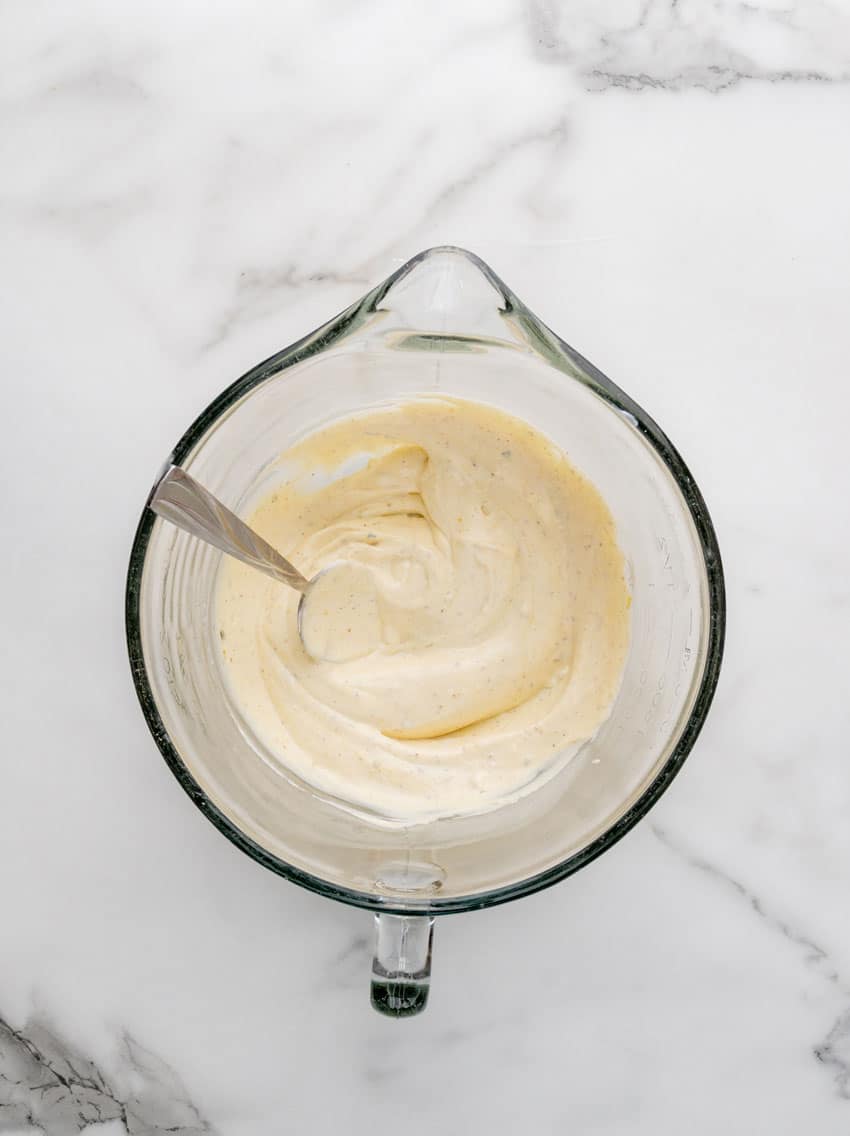 a homemade creamy dressing in a glass mixing bowl