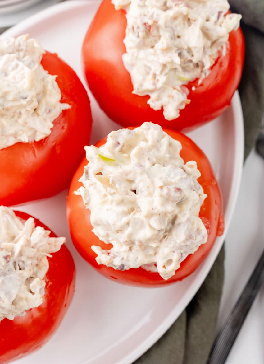 CHICKEN BACON RANCH SALAD STUFFED TOMATOES ON A WHITE SERVING PLATTER