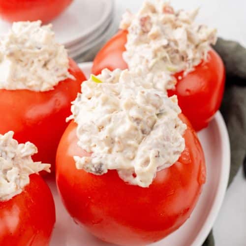 CHICKEN BACON RANCH SALAD STUFFED TOMATOES ON A WHITE SERVING PLATTER