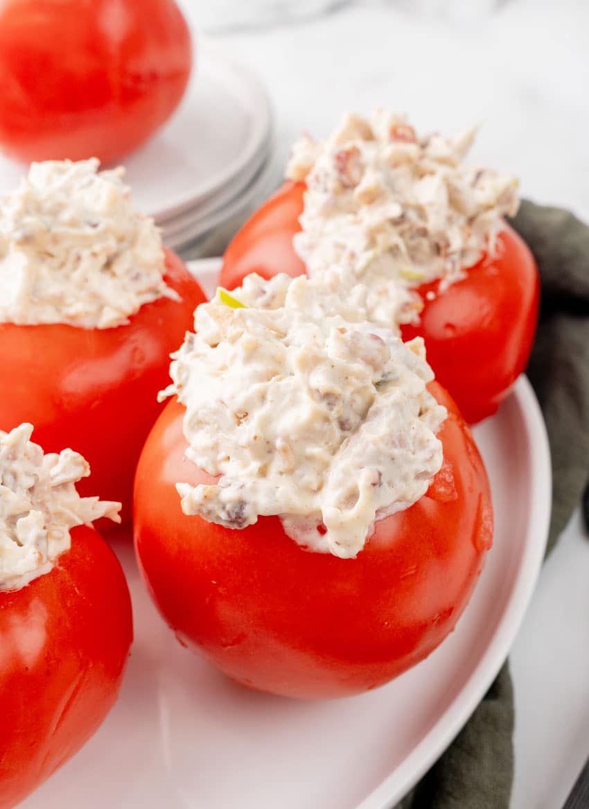 CHICKEN BACON RANCH SALAD STUFFED TOMATOES ON A WHITE SERVING PLATTER