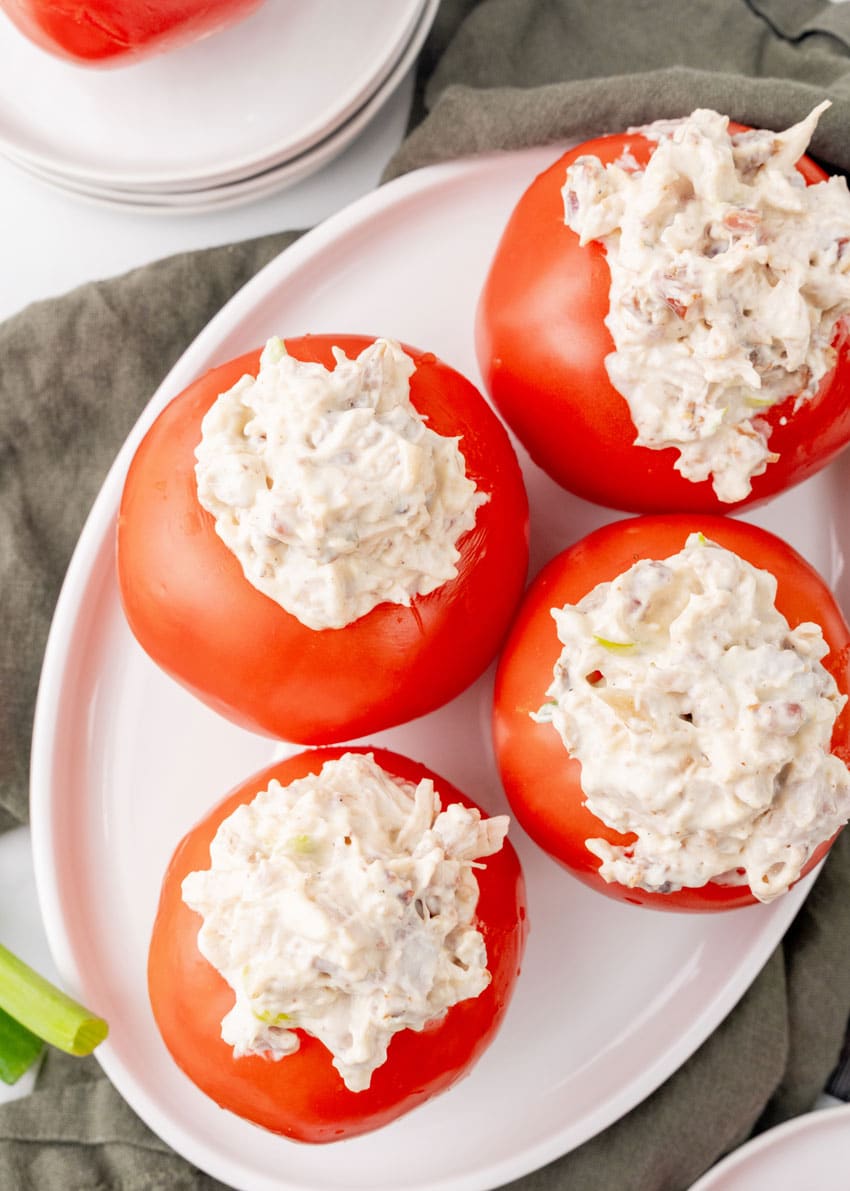 CHICKEN BACON RANCH SALAD STUFFED TOMATOES ON A WHITE SERVING PLATTER