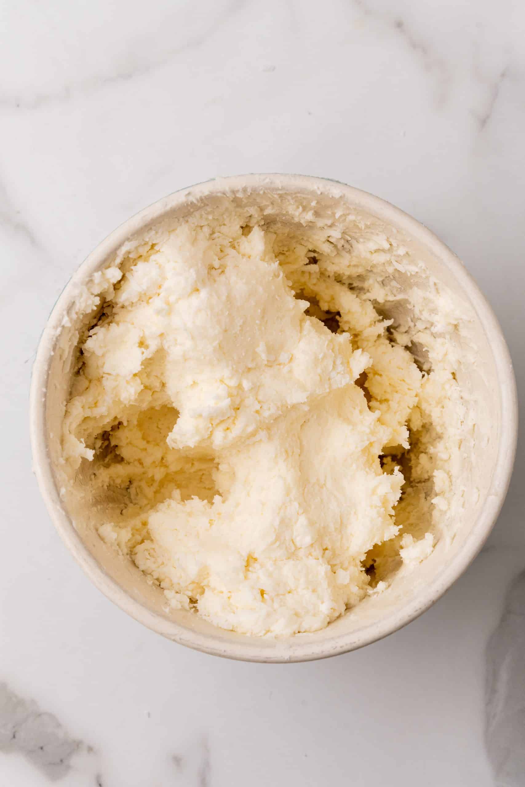 coconut candy mixture in a white mixing bowl