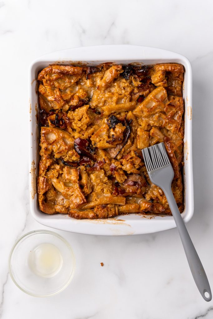 butter braised baked bread pudding in a white square baking dish