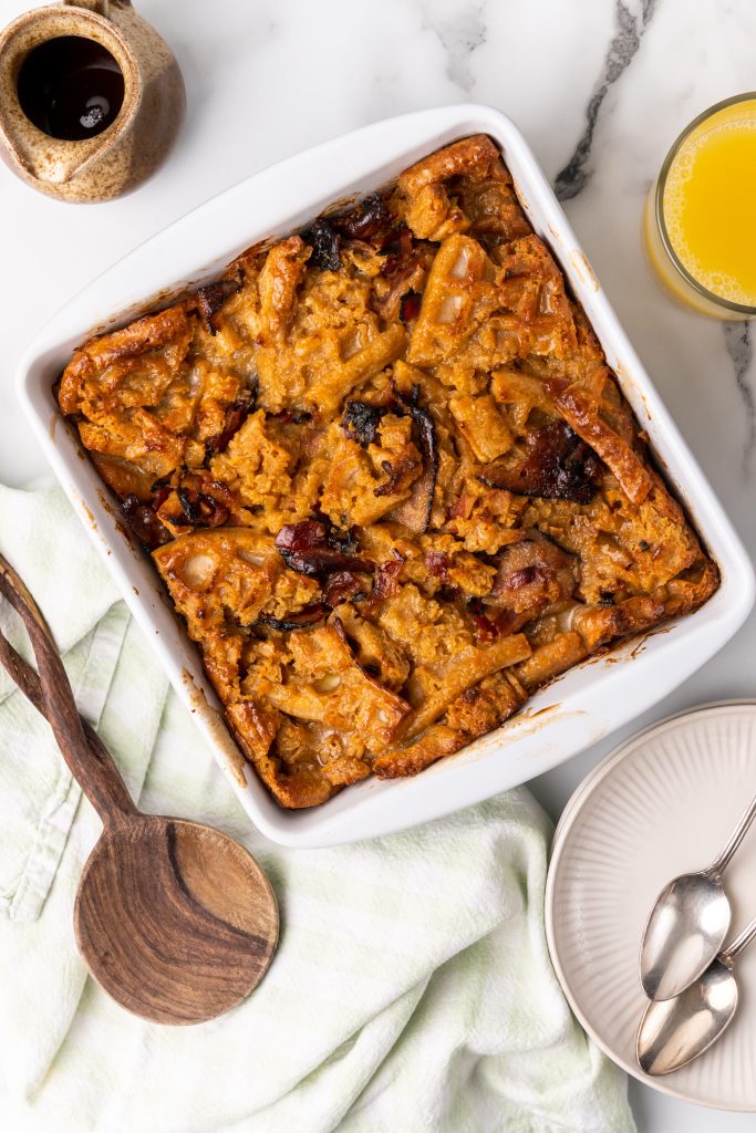 baked bread pudding with waffles in a white square baking dish