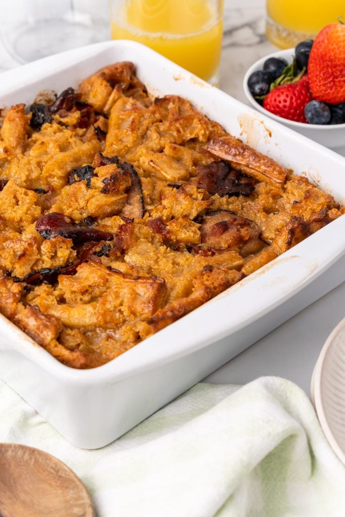 maple bacon waffle bread pudding in a white square baking dish