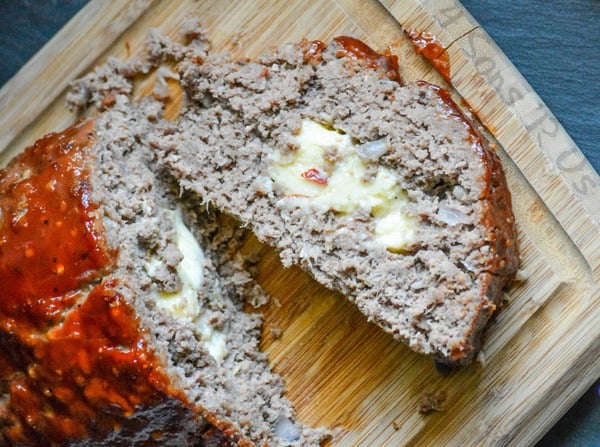 All Jack'd Up Stuffed Smoked Meatloaf sliced open to show the melted cheesy pepper jack in the center of the cooked loaf
