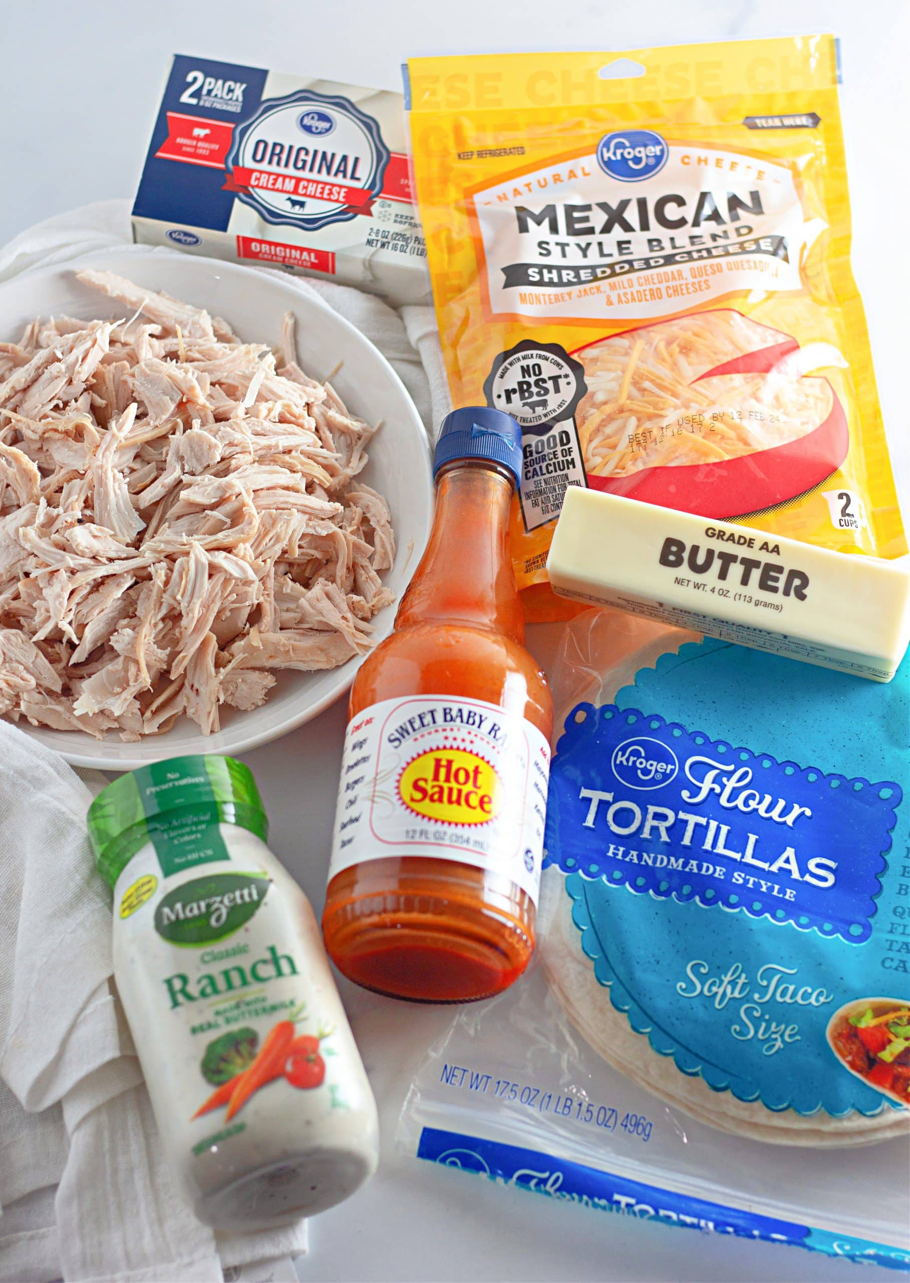 an overhead image showing the measured ingredients needed to make a batch of creamy buffalo chicken quesadillas