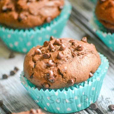 chocolate chocolate chip mocha muffins in teal cupcake wrappers on a wooden table