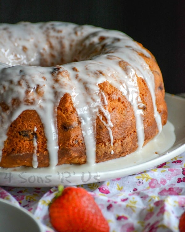 Glazed Strawberry Lemon Yogurt Cake on a white plate set on a pink floral napkin