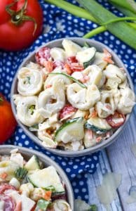summertime tortellini salad in two small gray bowls