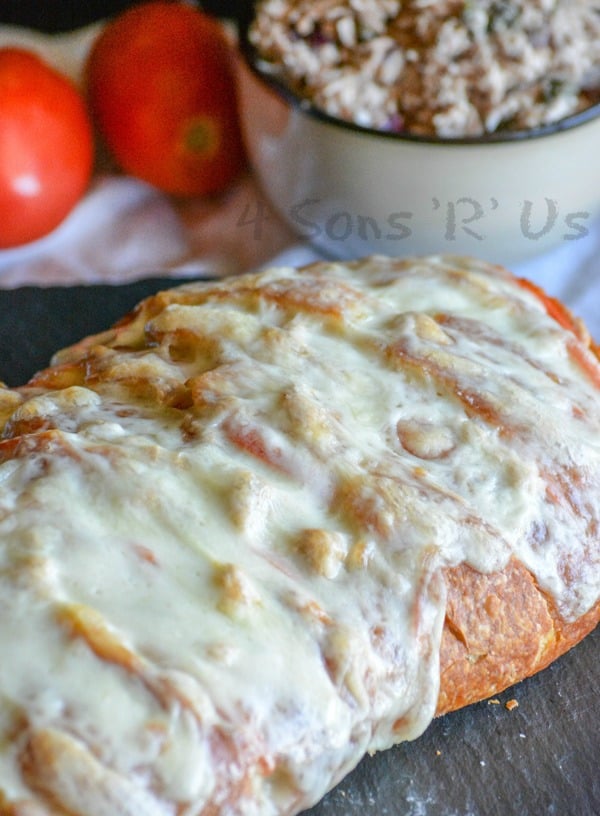 cheesy pull apart tuna melt loaf on a black slate cutting board